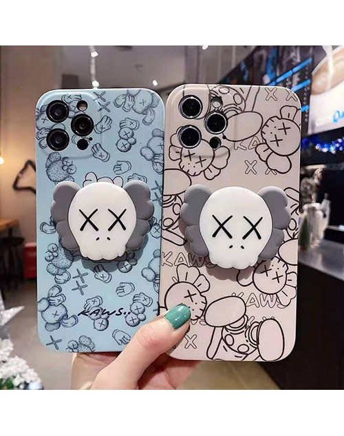 カウズ ブランドiphone12/12pro max/12 mini/12 pro maxケース KAWS ハンドバンド付き 韓国風 スタンドホルダー付 個性潮 リング iphone x/xr/xs/xs maxケース 落下防止 ファッション ins風 iphone 11/11 pro/11 pro maxケース かわいい iphone x/8/7 plusケース レディース